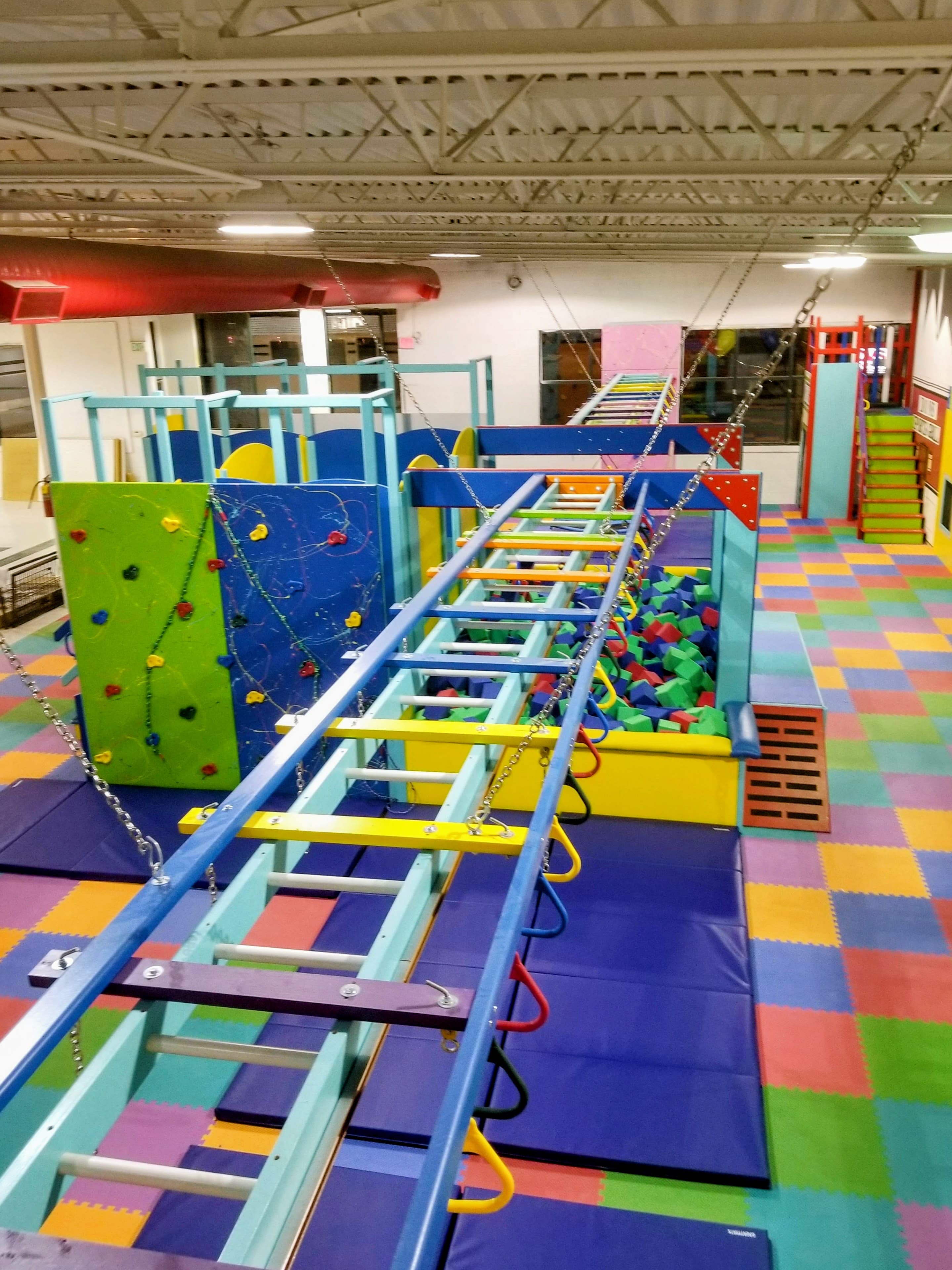 Custom climbing wall with safety crash pad below
