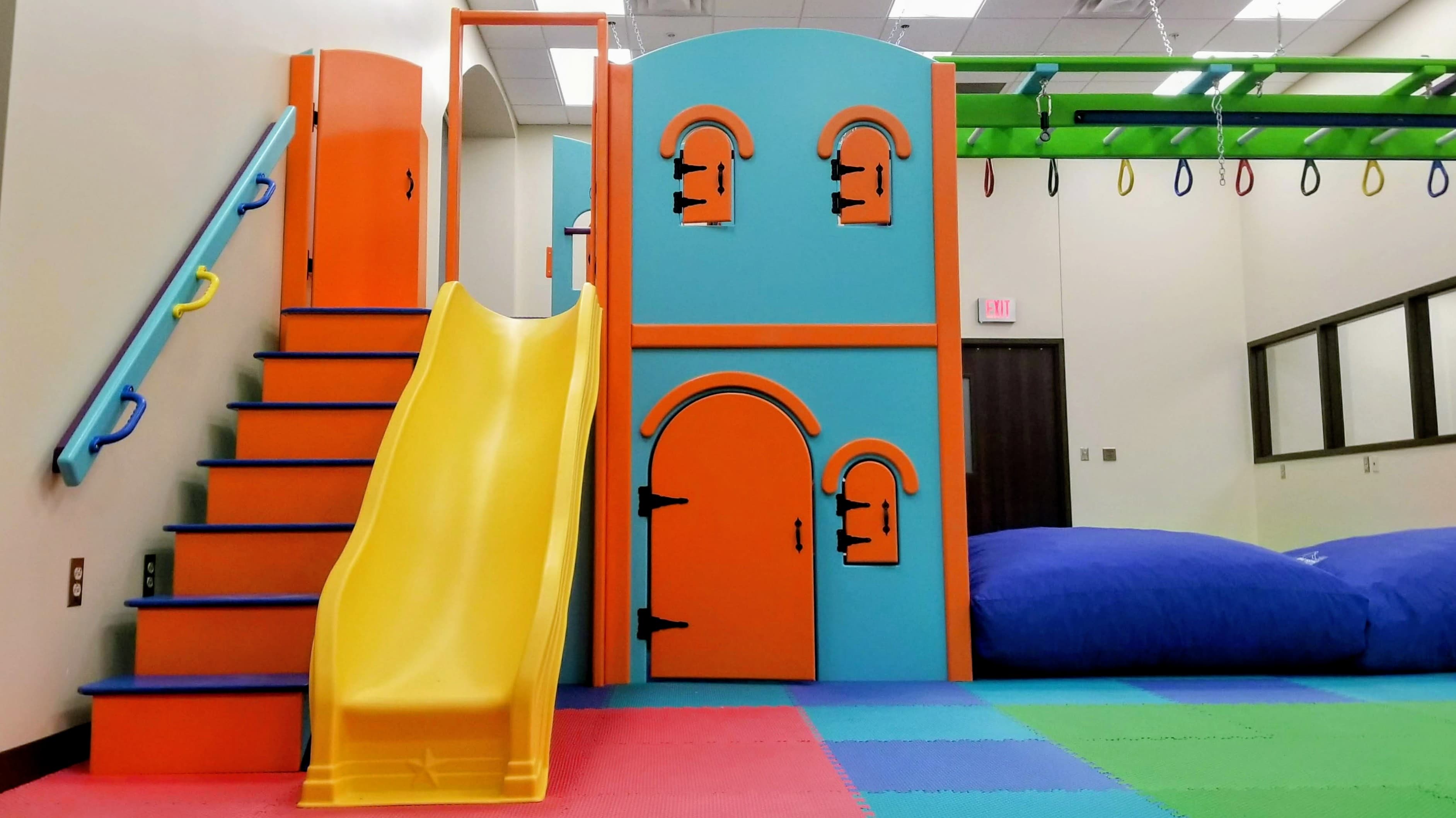 Custom clinic sensory gym with rings and slide